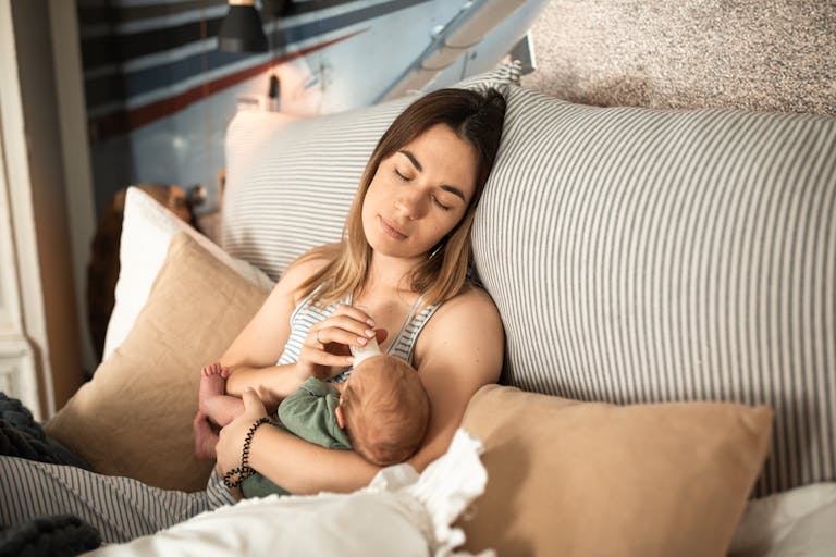 Peaceful moment of a mother and newborn baby relaxing at home. How to Deal With Anxiety in Pregnancy: 7 Calming Tricks