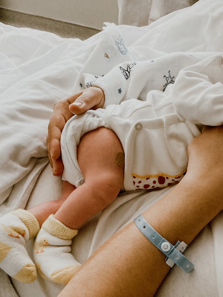 Tender moment captured between mother and newborn baby in a hospital setting. Hospital Delivery Bag Checklist: What Mom-to-Be Should Pack